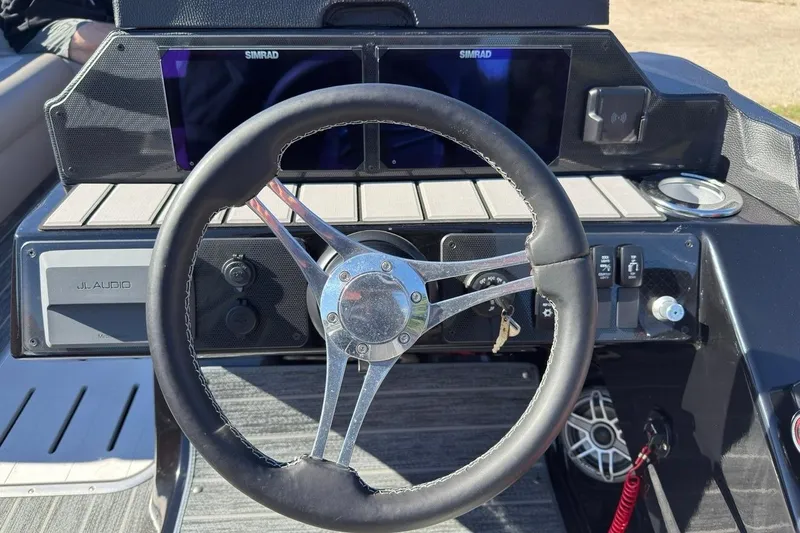 Slide: The Image of 2024 Premier 250 Solaris boat dashboard with steering wheel and Simrad displays. - 7