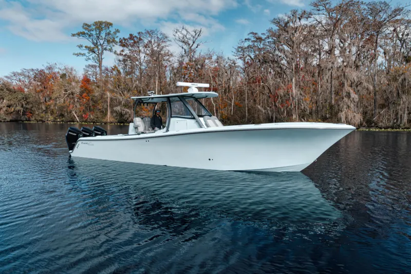 The Image of 2026 Front Runner 36' Center Console boat on a serene lake with autumn trees. - 0