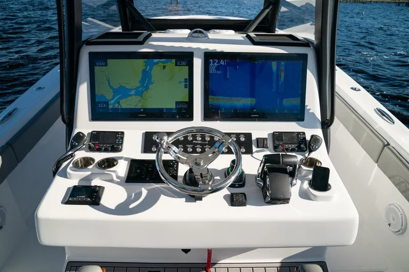 Slide: The Image of 2026 Front Runner 36' Center Console boat dashboard with dual navigation screens. - 11