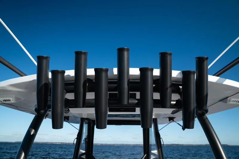 Slide: The Image of 2026 Front Runner 36' Center Console boat with rod holders against blue sky. - 14