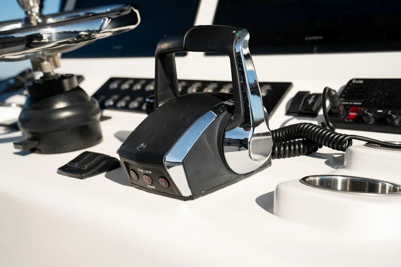 Slide: The Image of Control panel of 2026 Front Runner 36' Center Console boat, featuring throttle and steering wheel. - 18