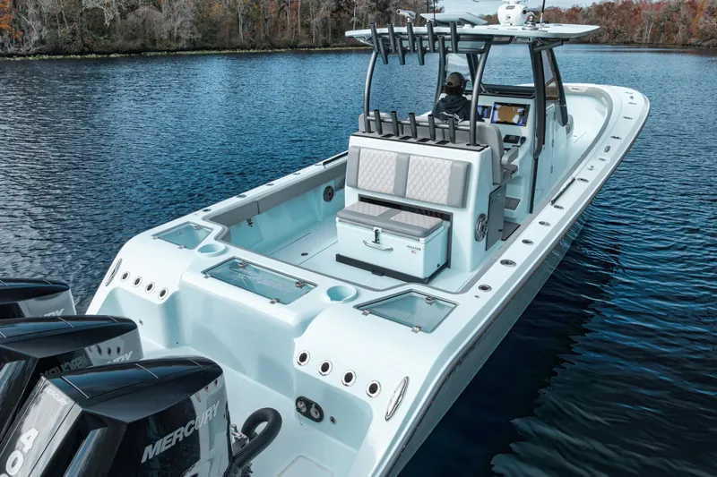 Slide: The Image of 2026 Front Runner 36' Center Console boat on calm water, featuring multiple outboard engines. - 2
