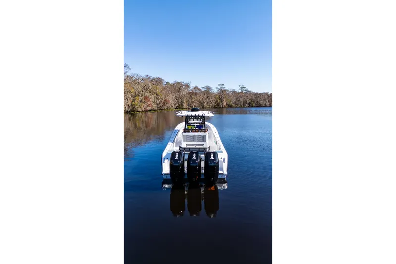 Slide: The Image of 2026 Front Runner 36' Center Console boat on a serene lake. - 8
