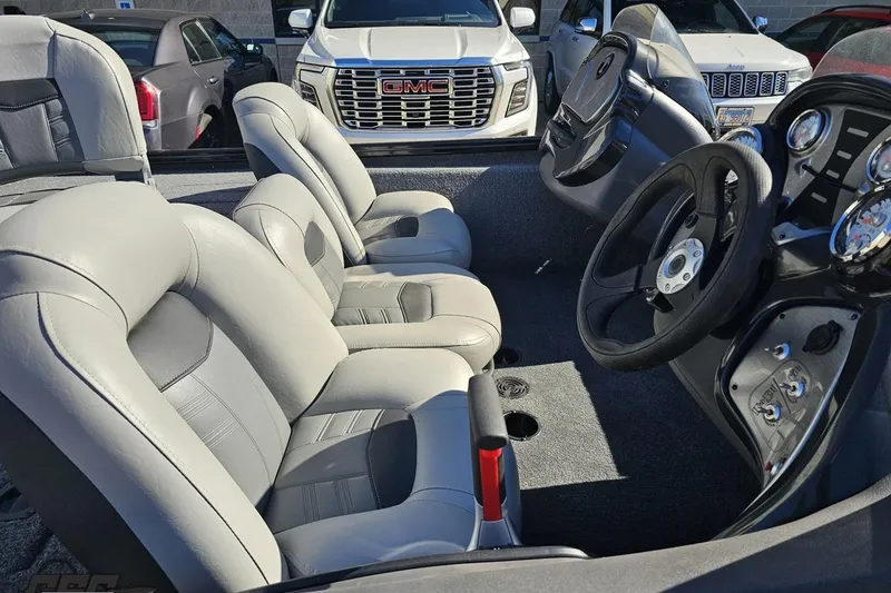 Slide: The Image of 2018 Tracker Pro Team 175 TXW boat interior with gray seats and steering console. - 10