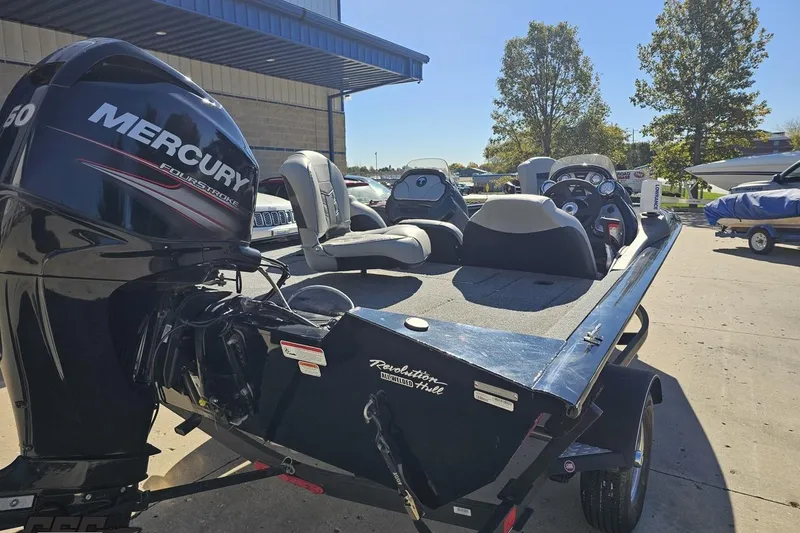Slide: The Image of 2018 Tracker Pro Team 175 TXW boat with Mercury engine, parked outdoors. - 14