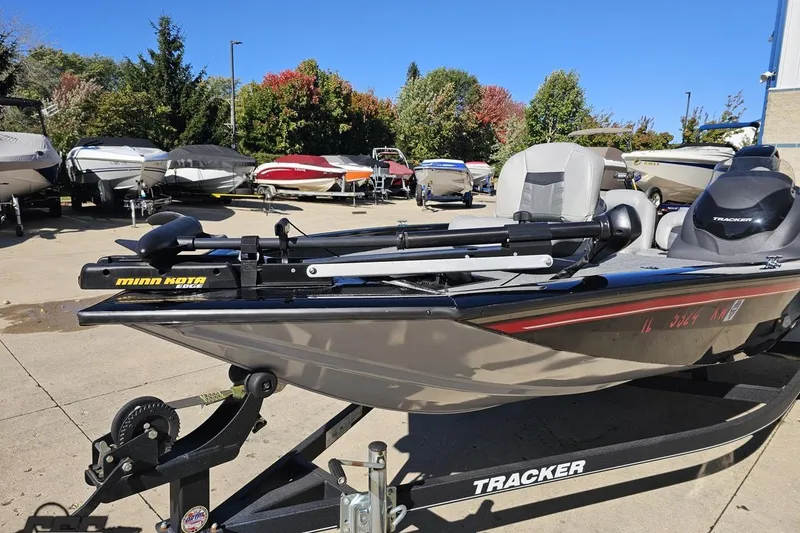 Slide: The Image of 2018 Tracker Pro Team 175 TXW boat with Minn Kota trolling motor in a marina. - 21