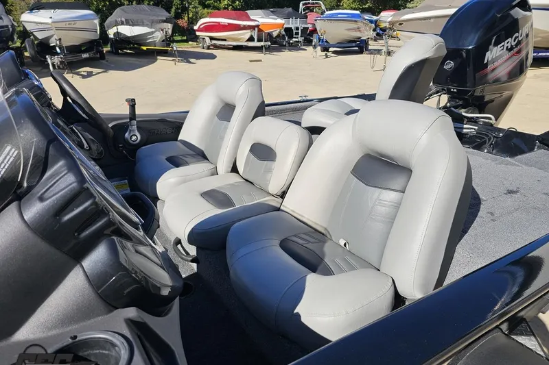 Slide: The Image of 2018 Tracker Pro Team 175 TXW boat interior with gray seating and steering console. - 29