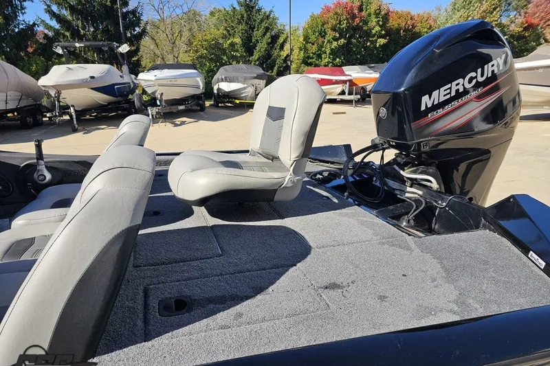 Slide: The Image of 2018 Tracker Pro Team 175 TXW boat with Mercury engine, parked among other boats. - 30