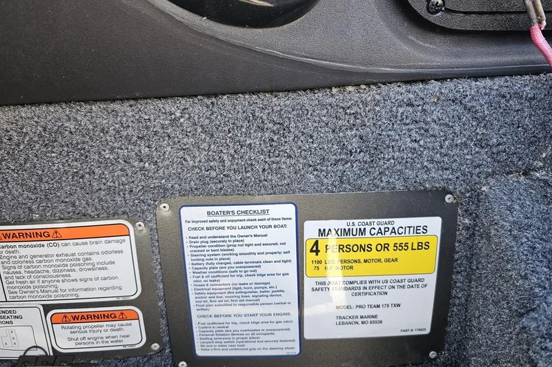 Slide: The Image of 2018 Tracker Pro Team 175 TXW capacity and safety warning labels on boat interior. - 55