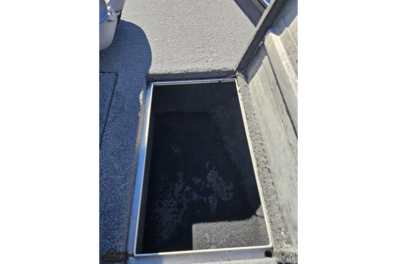 Slide: The Image of 2018 Tracker Pro Team 175 TXW boat storage compartment with carpeted interior. - 58