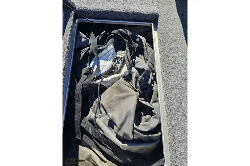 Slide: The Image of Storage compartment in 2018 Tracker Pro Team 175 TXW boat with gear and equipment. - 59