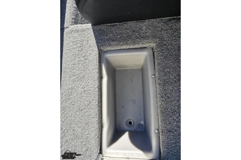 Slide: The Image of 2018 Tracker Pro Team 175 TXW boat storage compartment with gray carpet interior. - 64