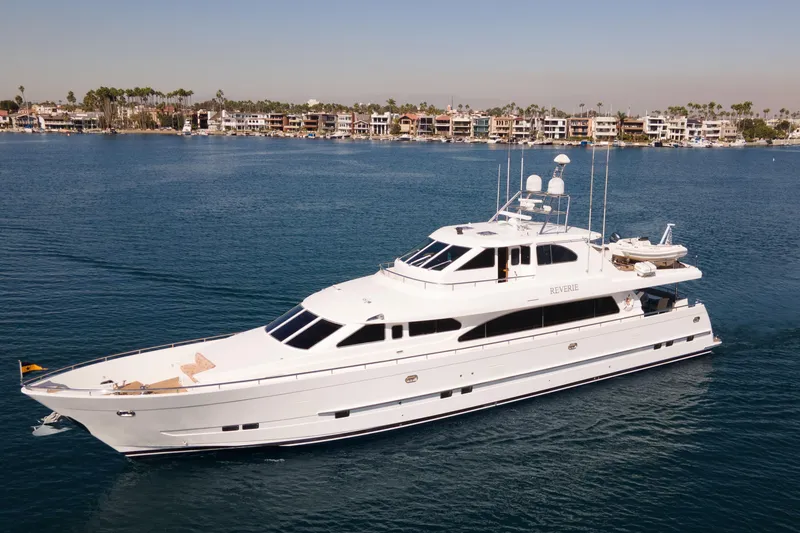 The Image of Luxurious 2005 custom yacht "Reverie" cruising near coastal homes. - 0
