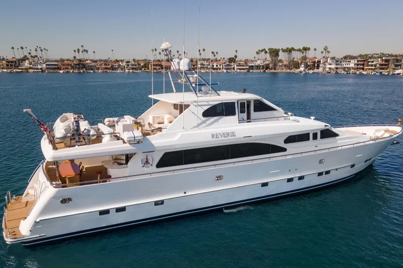 Slide: The Image of Luxurious 2005 Custom yacht cruising near coastal homes and palm trees. - 13