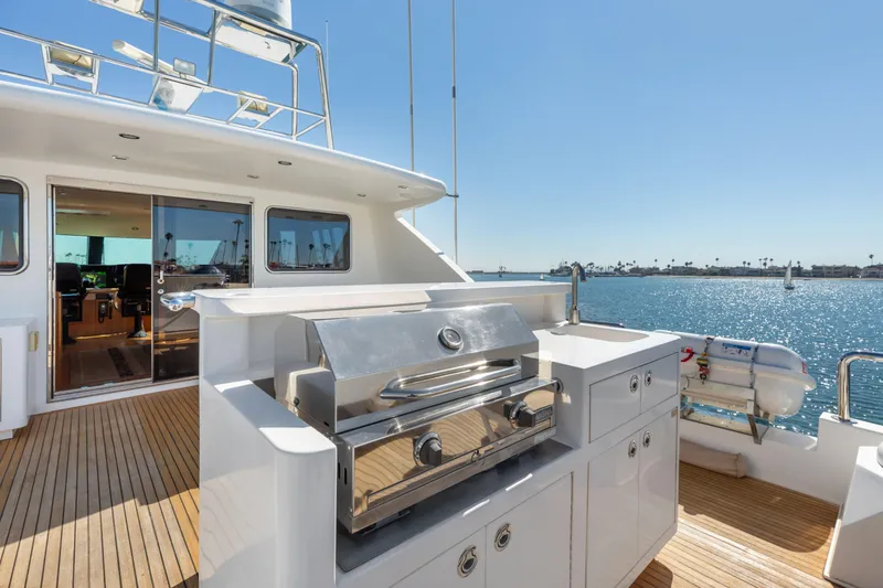 Slide: The Image of Luxury yacht deck with seating, bar stools, and scenic waterfront view. - 21