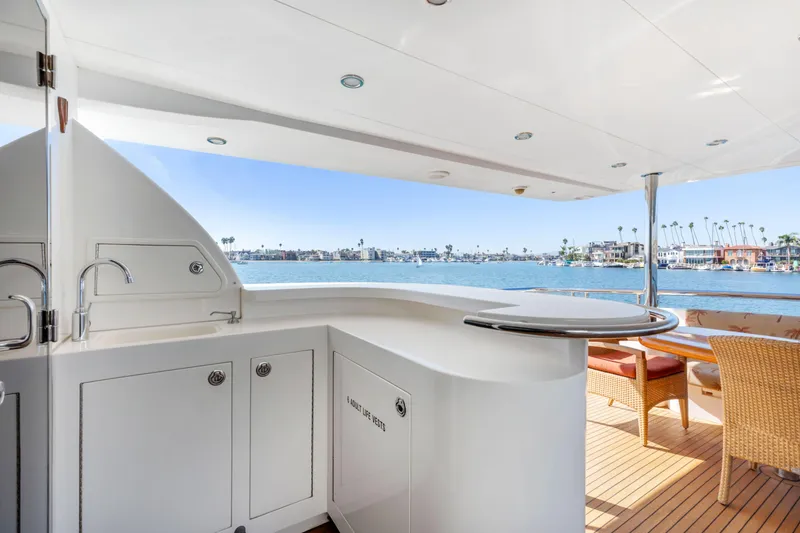 Slide: The Image of Luxurious 2005 Custom yacht deck with seating, bar, and scenic waterfront view. - 30