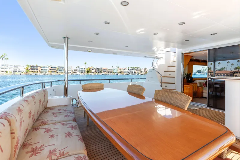 Slide: The Image of Luxurious yacht deck with dining area, overlooking serene waterfront and coastal homes, 2005 Custom model. - 34
