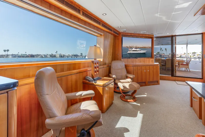 Slide: The Image of Luxurious yacht interior with plush seating, wooden accents, and large windows overlooking the water. - 39