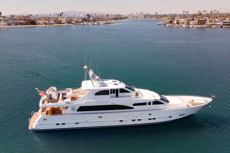 Slide: The Image of Luxury yacht cruising near coastal homes, 2005 Custom model, with a sailboat in the background. - 4