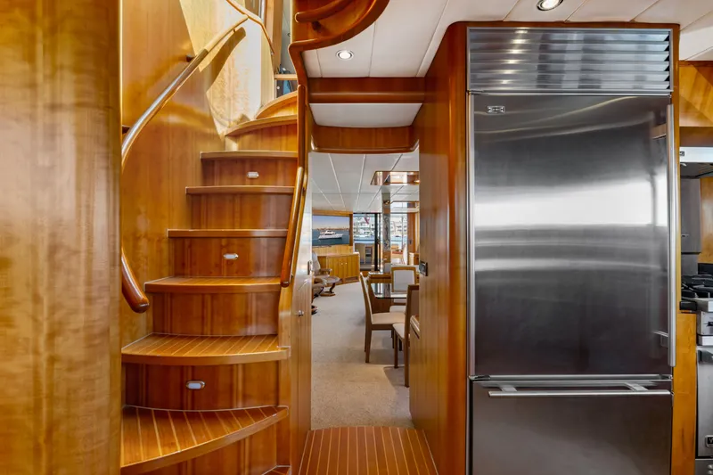 Slide: The Image of Luxurious yacht bedroom with wooden decor, cozy bed, and elegant seating area, 2005 Custom model. - 52