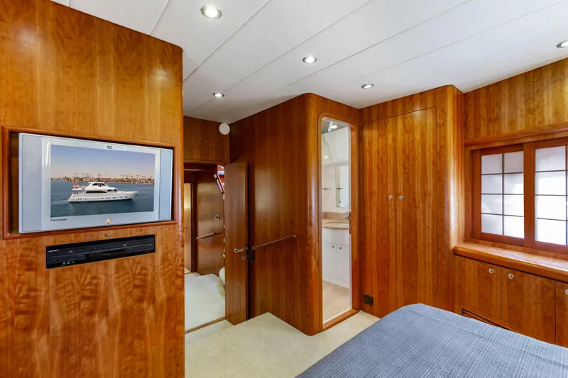 Slide: The Image of Luxurious yacht bedroom with twin beds, wooden cabinetry, and elegant lighting, 2005 Custom model. - 62