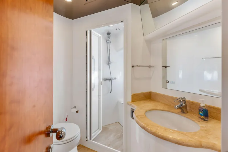 Slide: The Image of Modern bathroom with granite countertop, sink, and mirror in a 2005 Custom model. - 63