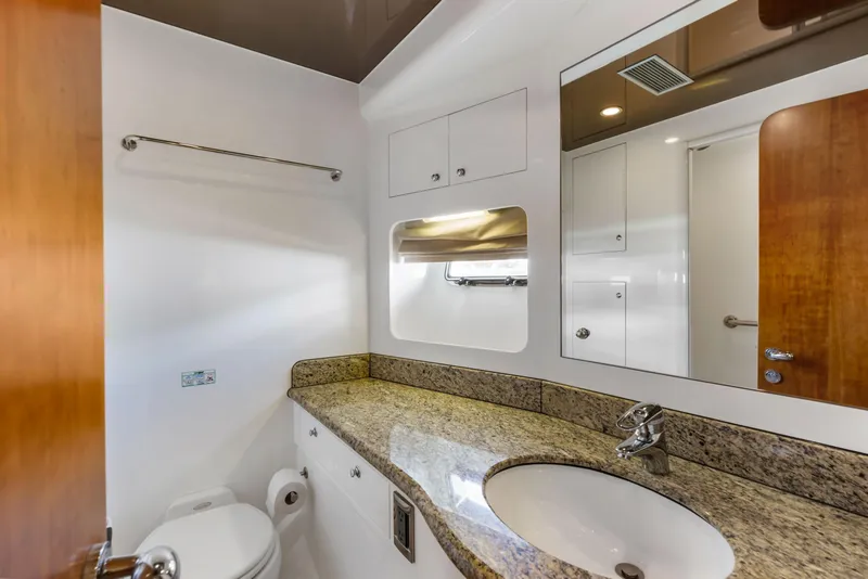 Slide: The Image of Luxurious yacht interior with wooden cabinetry, stainless steel appliances, and a view of the marina. - 65