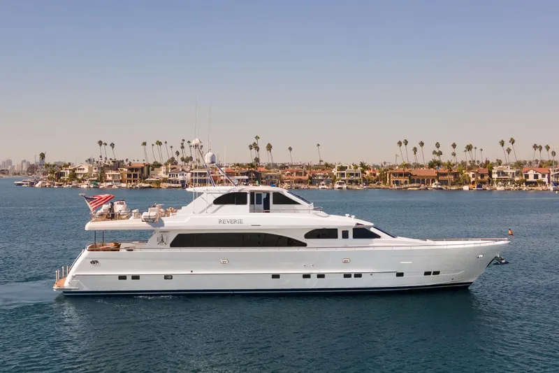 Slide: The Image of Luxurious 2005 Custom yacht cruising in a sunny marina with palm trees in the background. - 7