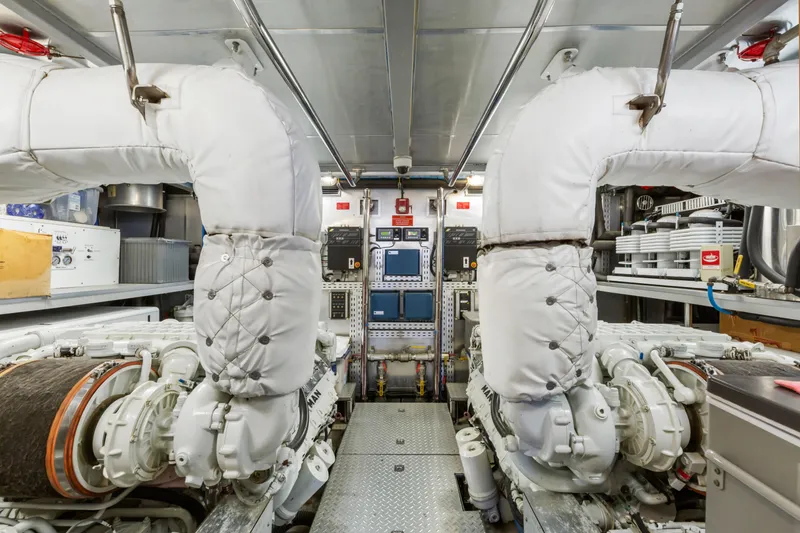 Slide: The Image of Engine room of a 2005 C Custom model, featuring dual engines and safety equipment. - 73