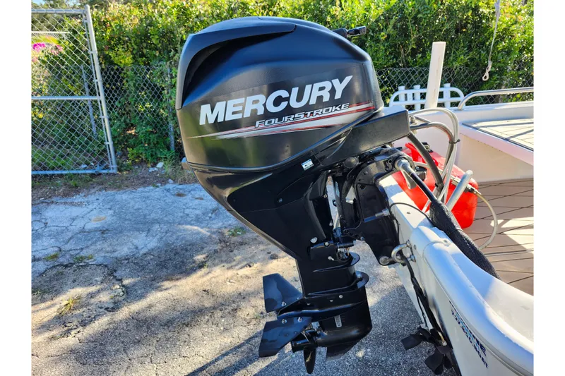 Slide: The Image of Mercury FourStroke engine on a 2020 Boston Whaler 110 Sport boat, outdoor setting. - 14
