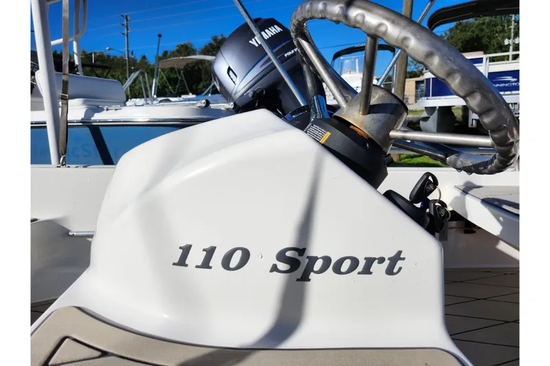Slide: The Image of 2020 Boston Whaler 110 Sport boat steering wheel and console detail. - 16