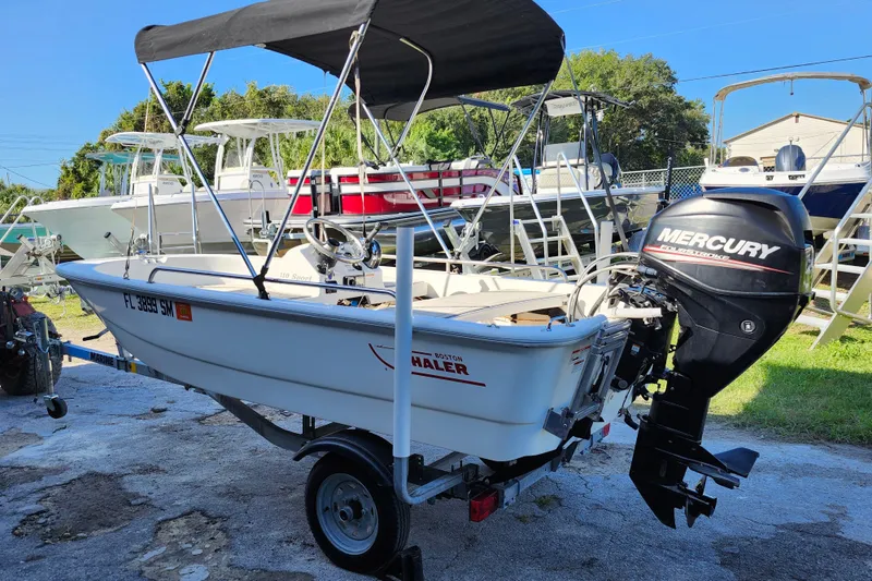 Slide: The Image of 2020 Boston Whaler 110 Sport boat with Mercury engine on trailer. - 4