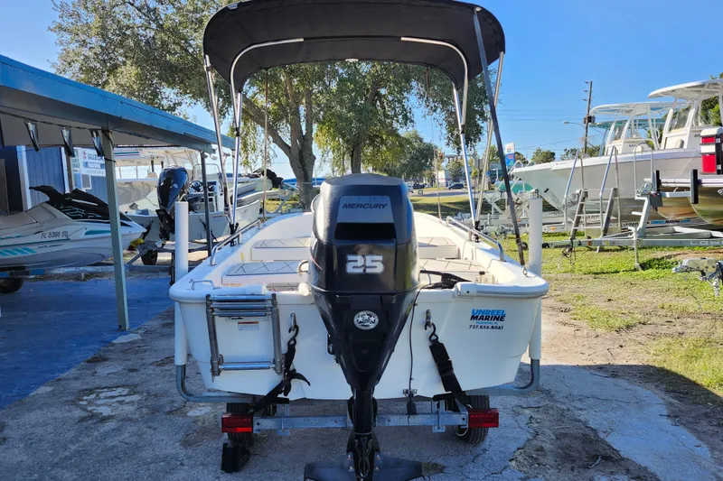Slide: The Image of 2020 Boston Whaler 110 Sport boat with Mercury 25 engine, parked outdoors. - 5