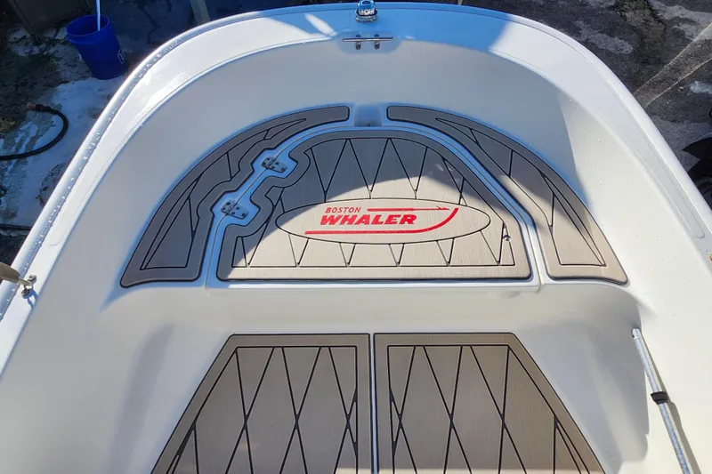 Slide: The Image of 2020 Boston Whaler 110 Sport boat interior with custom flooring and logo. - 8