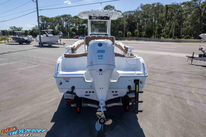 Slide: The Image of 2026 Sea Hunt Ultra 255 SE boat with powerful V6 engine, parked outdoors. - 10