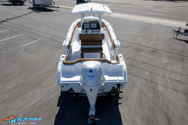 Slide: The Image of 2026 Sea Hunt Ultra 255 SE boat with Yamaha engine, parked on asphalt. - 12