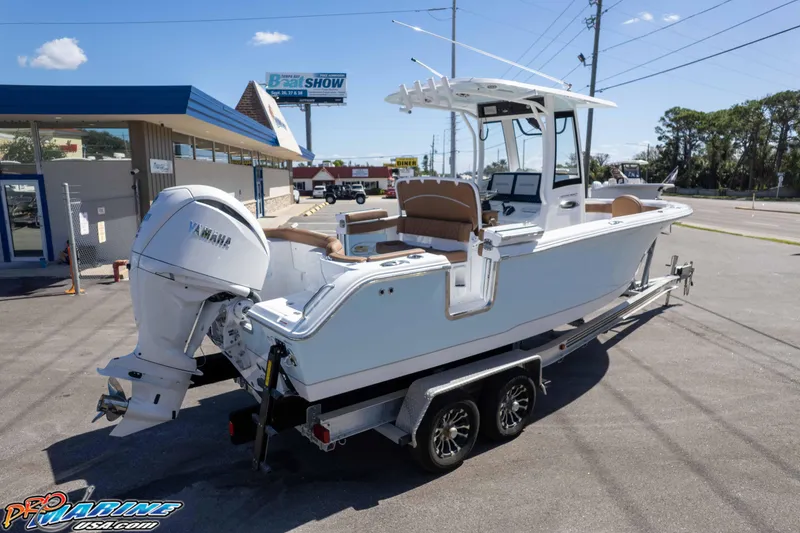 Slide: The Image of 2026 Sea Hunt Ultra 255 SE boat on trailer, parked outdoors near dealership. - 13