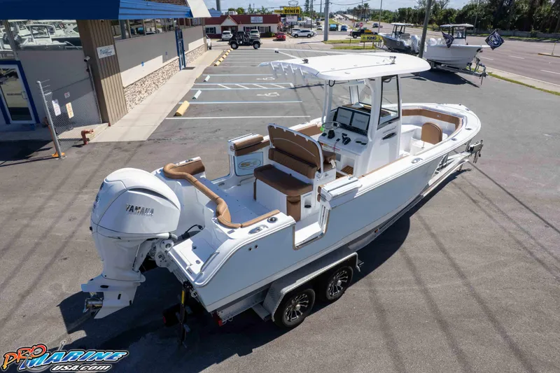 Slide: The Image of 2026 Sea Hunt Ultra 255 SE boat on trailer, parked outside dealership. - 14