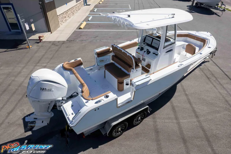 Slide: The Image of 2026 Sea Hunt Ultra 255 SE boat with Yamaha engine on trailer in parking lot. - 15
