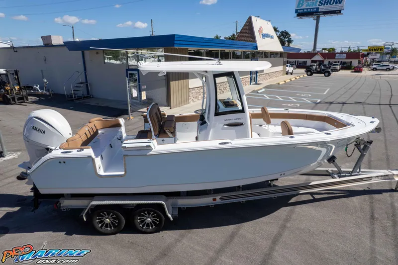 Slide: The Image of 2026 Sea Hunt Ultra 255 SE boat on trailer at dealership parking lot. - 17