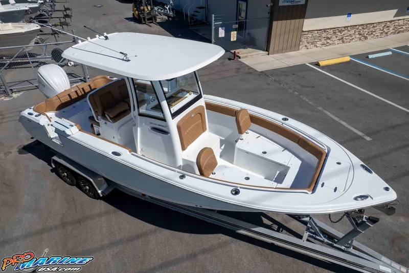 Slide: The Image of 2026 Sea Hunt Ultra 255 SE boat on trailer, parked in a marina lot. - 19