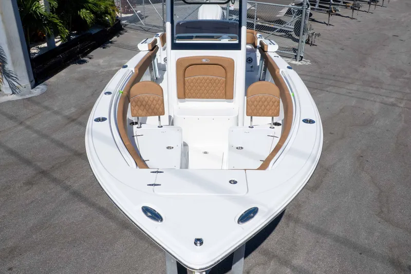 Slide: The Image of 2026 Sea Hunt Ultra 255 SE boat with tan seating and sleek white design. - 21