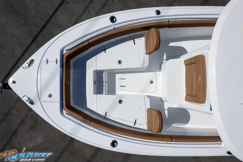 Slide: The Image of 2026 Sea Hunt Ultra 255 SE boat interior with tan seating and white deck. - 23