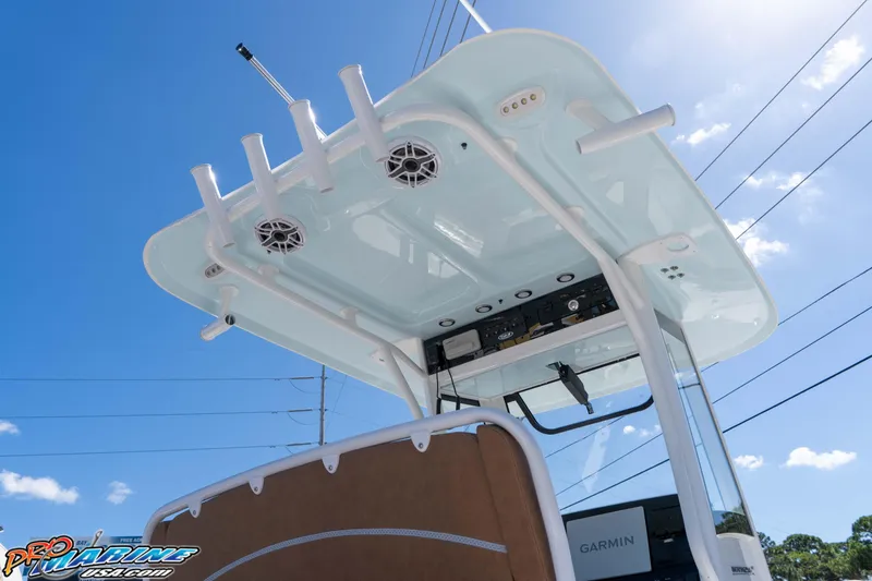 Slide: The Image of 2026 Sea Hunt Ultra 255 SE boat with advanced electronics and rod holders under a clear blue sky. - 28