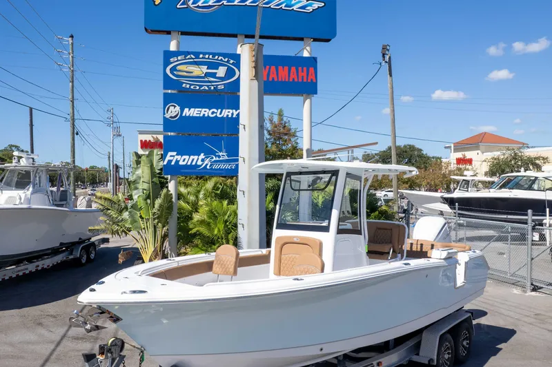 Slide: The Image of 2026 Sea Hunt Ultra 255 SE boat on trailer at dealership, sunny day. - 3