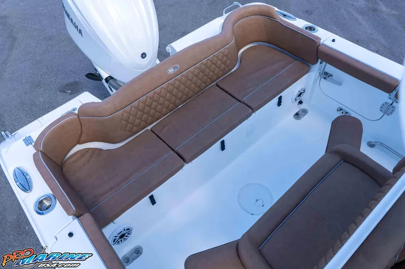 Slide: The Image of 2026 Sea Hunt Ultra 255 SE boat interior with brown cushioned seating and Yamaha engine. - 31