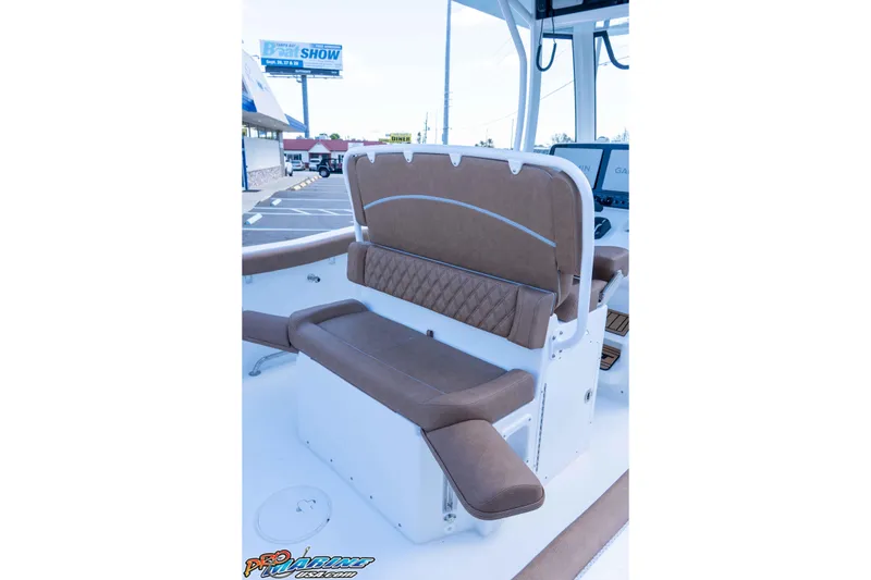 Slide: The Image of 2026 Sea Hunt Ultra 255 SE boat interior with brown cushioned seating. - 32