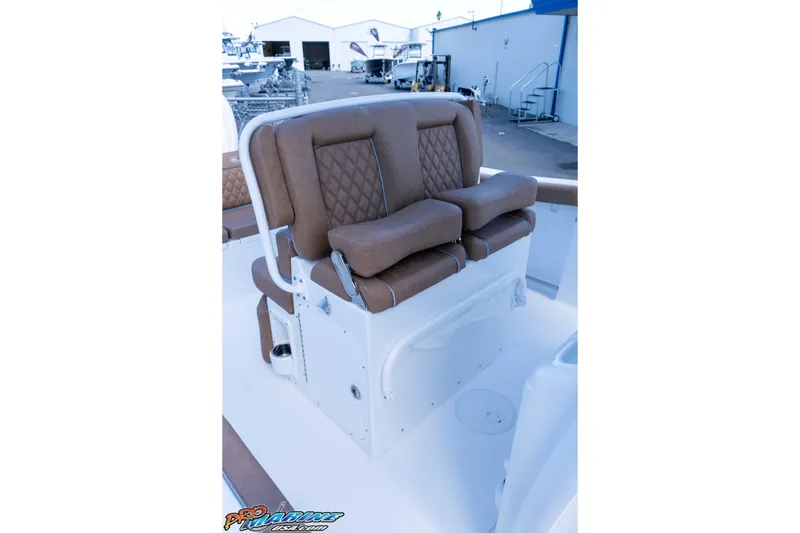 Slide: The Image of 2026 Sea Hunt Ultra 255 SE boat with brown cushioned seating. - 33