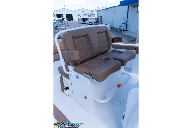 Slide: The Image of 2026 Sea Hunt Ultra 255 SE boat seating with brown cushioned seats and white frame. - 34