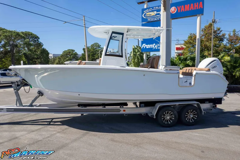 Slide: The Image of 2026 Sea Hunt Ultra 255 SE boat on trailer at dealership, featuring Yamaha engine. - 4